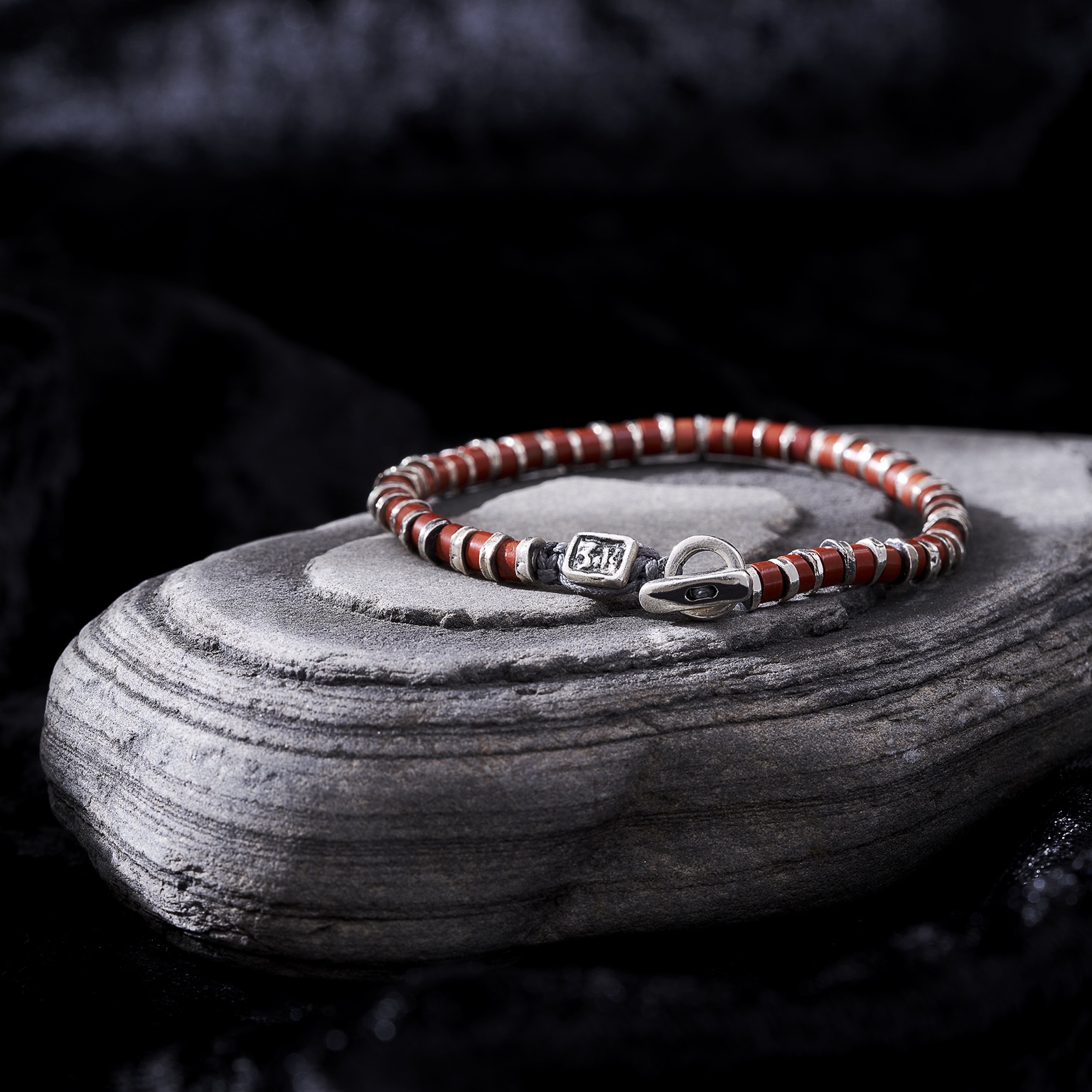 Red bracelet on stone